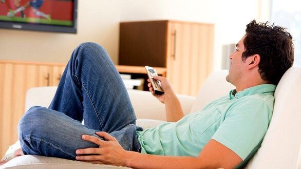 The man watches television